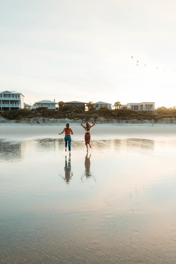 Two women enjoying a peaceful walk on the beach during sunset in Avon Park, FL.